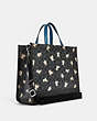 COACH®,DEMPSEY TOTE 40 IN SIGNATURE CANVAS WITH HAPPY DOG PRINT,Large,Silver/Graphite Multi,Angle View