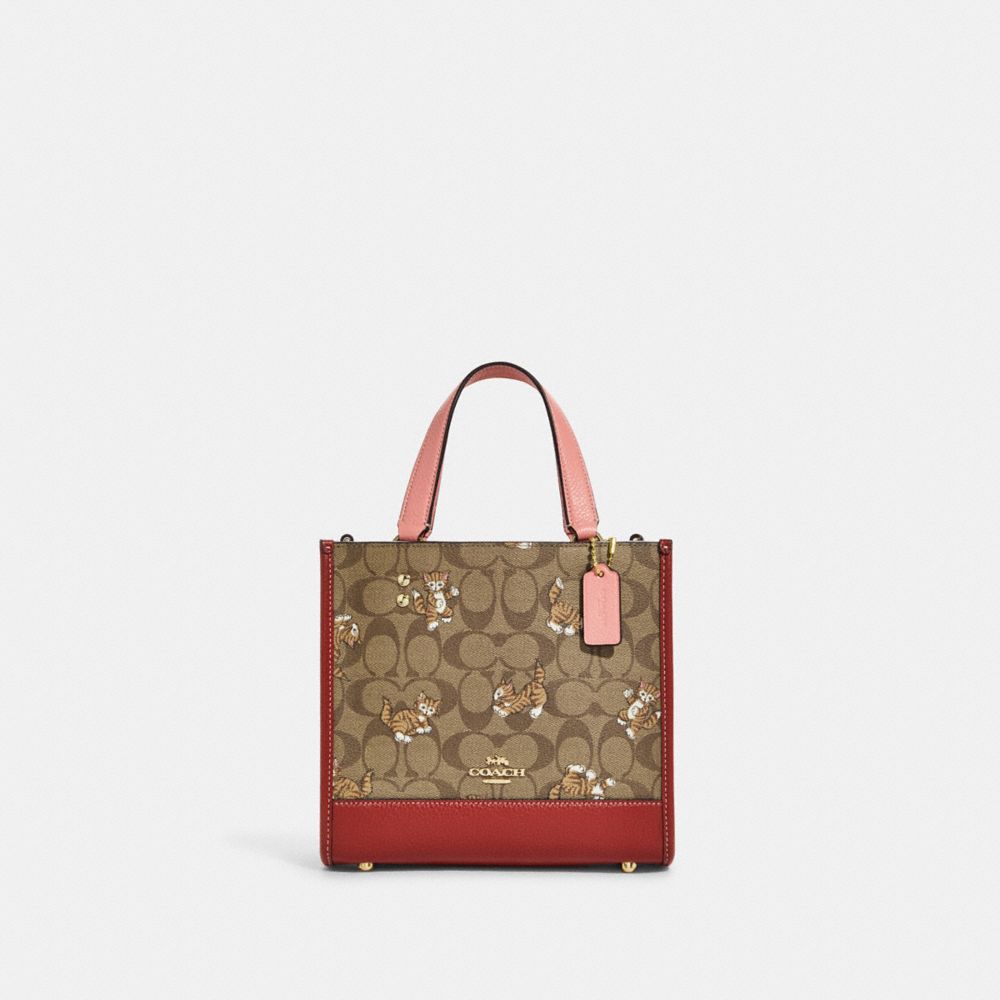 COACH®,DEMPSEY TOTE 22 IN SIGNATURE CANVAS WITH DANCING KITTEN PRINT,Medium,Gold/Khaki Multi,Front View