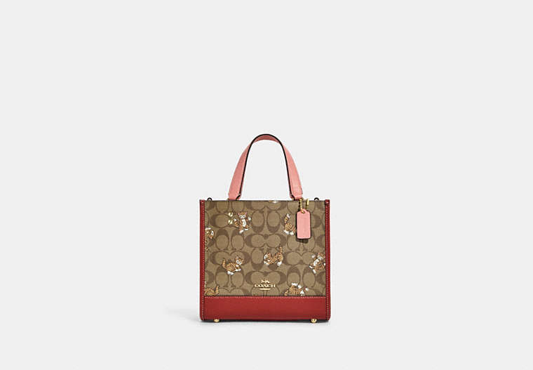 COACH®,DEMPSEY TOTE BAG 22 IN SIGNATURE CANVAS WITH DANCING KITTEN PRINT,Medium,Gold/Khaki Multi,Front View image number 0