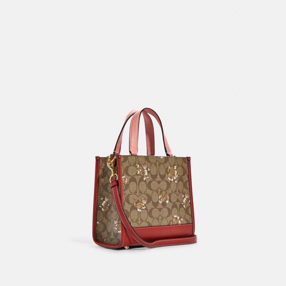 COACH®,DEMPSEY TOTE 22 IN SIGNATURE CANVAS WITH DANCING KITTEN PRINT,Medium,Gold/Khaki Multi,Angle View