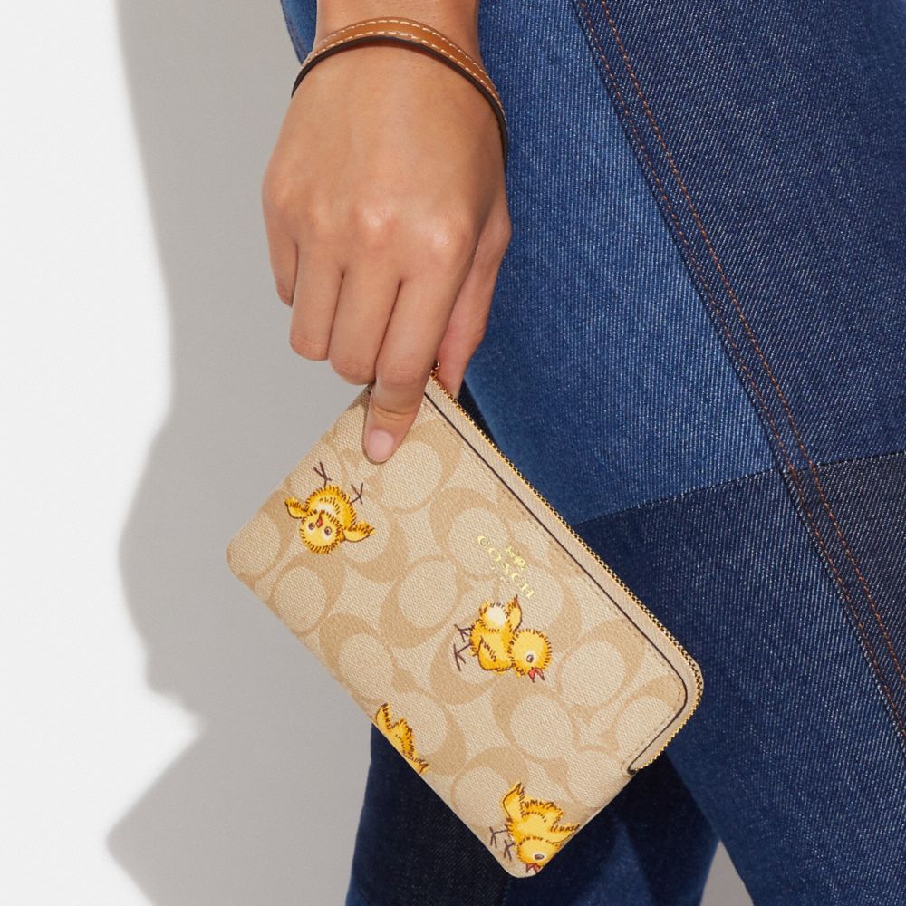 COACH®,CORNER ZIP WRISTLET IN SIGNATURE CANVAS WITH TOSSED CHICK PRINT,Mini,Gold/Light Khaki Multi,Detail View