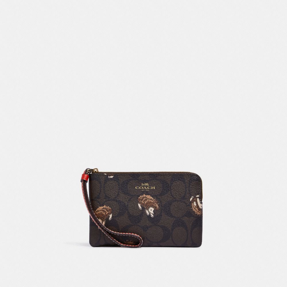 COACH®,CORNER ZIP WRISTLET IN SIGNATURE CANVAS WITH HEDGEHOG PRINT,Mini,Gold/Brown Black Multi,Front View