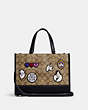 COACH®,DISNEY X COACH DEMPSEY CARRYALL IN SIGNATURE CANVAS WITH PATCHES,Signature Coated Canvas,Medium,Gold/Khaki Multi,Front View