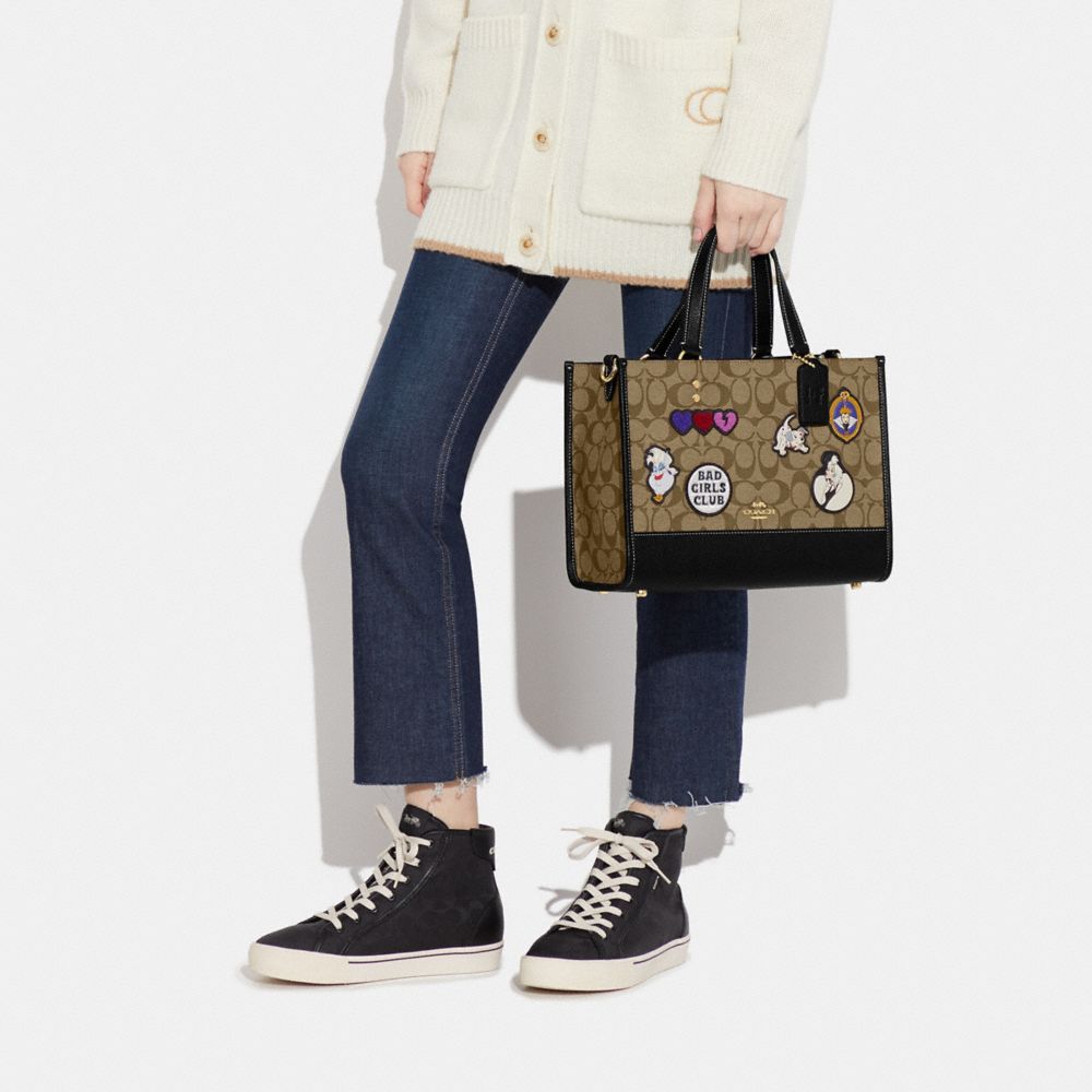 COACH®  Disney X Coach Dempsey Carryall With Cruella Motif