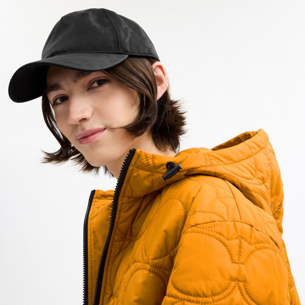 COACH®,Tonal Signature Baseball Hat,Nylon,Cotton,Baseball Cap,Metal,Graphic,Pattern,Grommet,Logo,Embossed,Cooling,Adjustab...,Black,Angle View