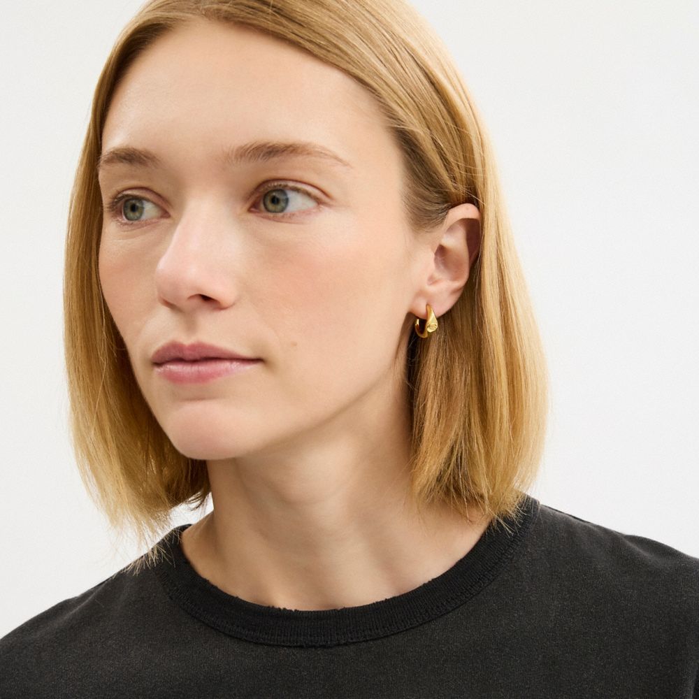 Coach Signet Signature Huggie Earrings In Gold