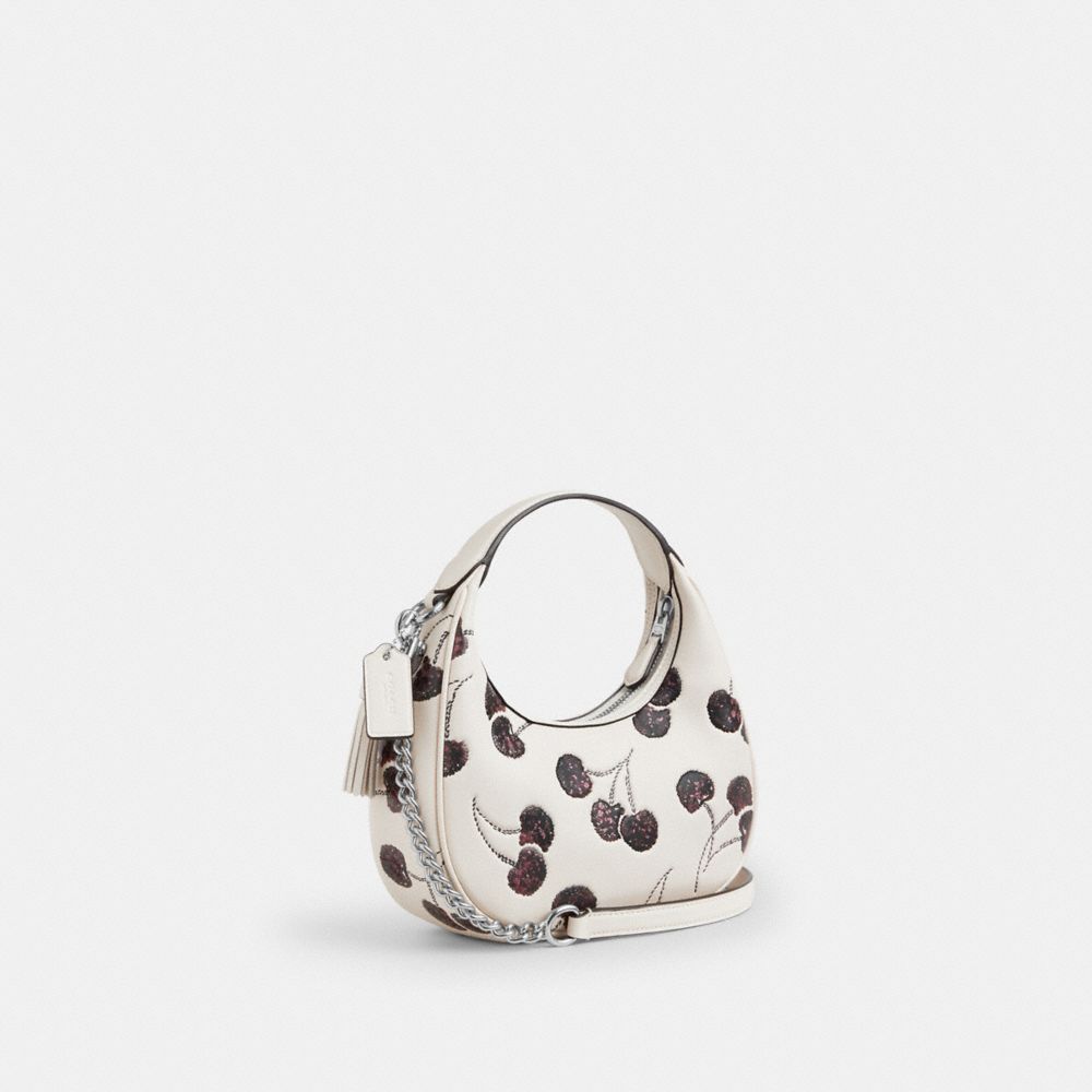 COACH®,Carmen Mini Crossbody Bag With Cherry Print,Leather,Crossbody,Tassel,Sequin,Glitter,Adjustable,Lined,Tear Resistant...,Cream,Angle View