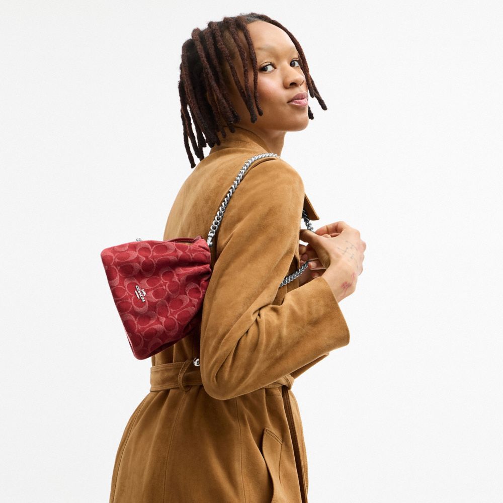 COACH®,Faye Mini Drawstring Bag In Signature Denim,Denim,Cotton,Leather,Bucket,Logo,Metal,Silver Metal,Day Party,Maroon,Detail View