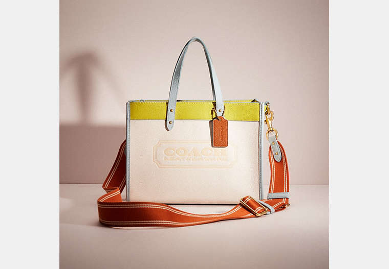 COACH®,RESTORED FIELD TOTE 30 IN COLORBLOCK WITH COACH BADGE,Polished Pebble Leather,Medium,Brass/Chalk Keylime Aqua,Front View