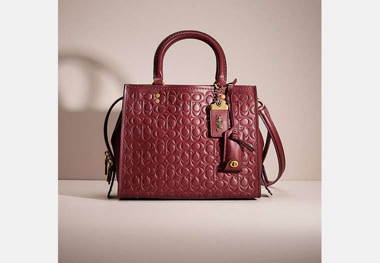 COACH®,RESTORED ROGUE 25 IN SIGNATURE LEATHER WITH FLORAL BOW PRINT INTERIOR,Smooth Leather,Medium,Brass/Bordeaux,Front View