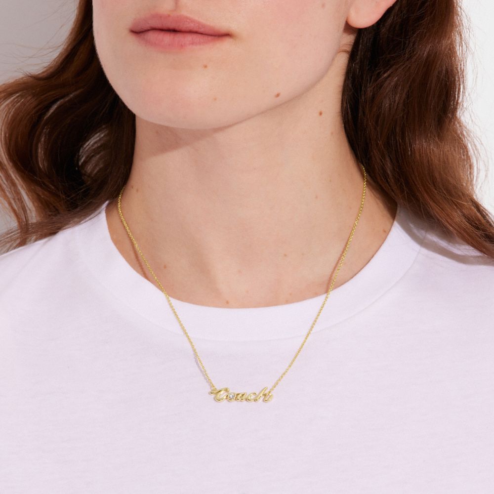 COACH®,LOGO SCRIPT NECKLACE,Gold,Detail View