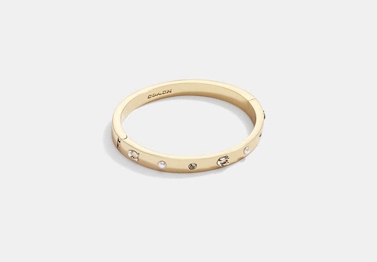 COACH®,PEGGED SIGNATURE AND STONE HINGED BANGLE,Brass,Gold/Black Diamond,Front View