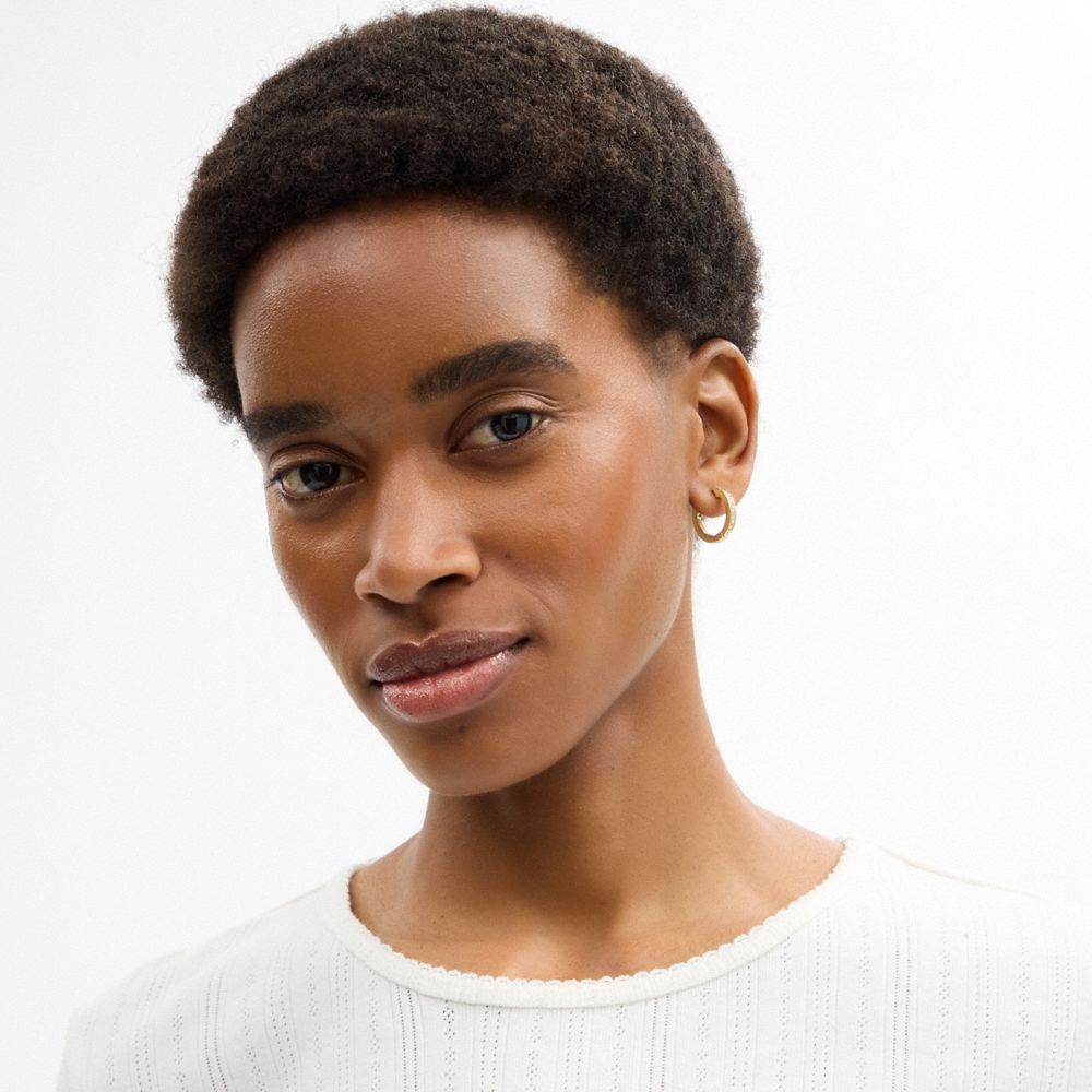 COACH®,Pearl Huggie Earrings,Hoops,Huggies,Cubic Zirconia,Crystal,Pearl,Glass,Pearl,Gem Embellishment,Titanium,Work,Gold,Detail View