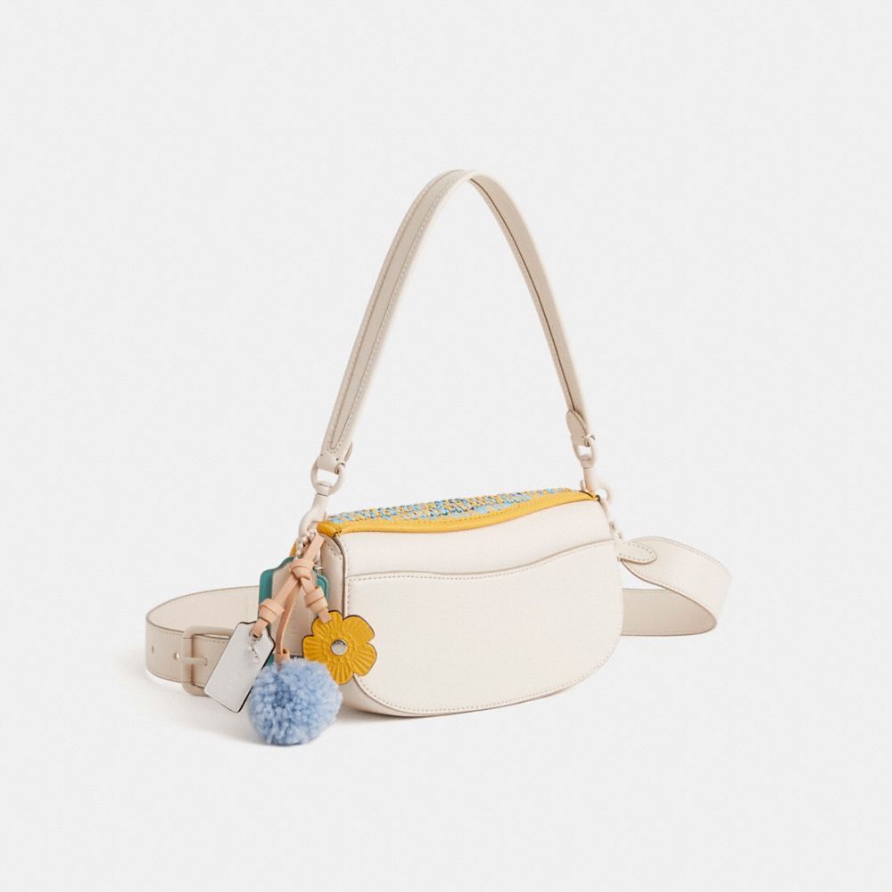 COACH®,Upcrafted Emmy Saddle Bag 23,Leather,Cotton,Saddle Bag,Straw,3D Embellishment,Logo,Pom Pom,Color Block,Metal,Mixed ...,Cream,Angle View