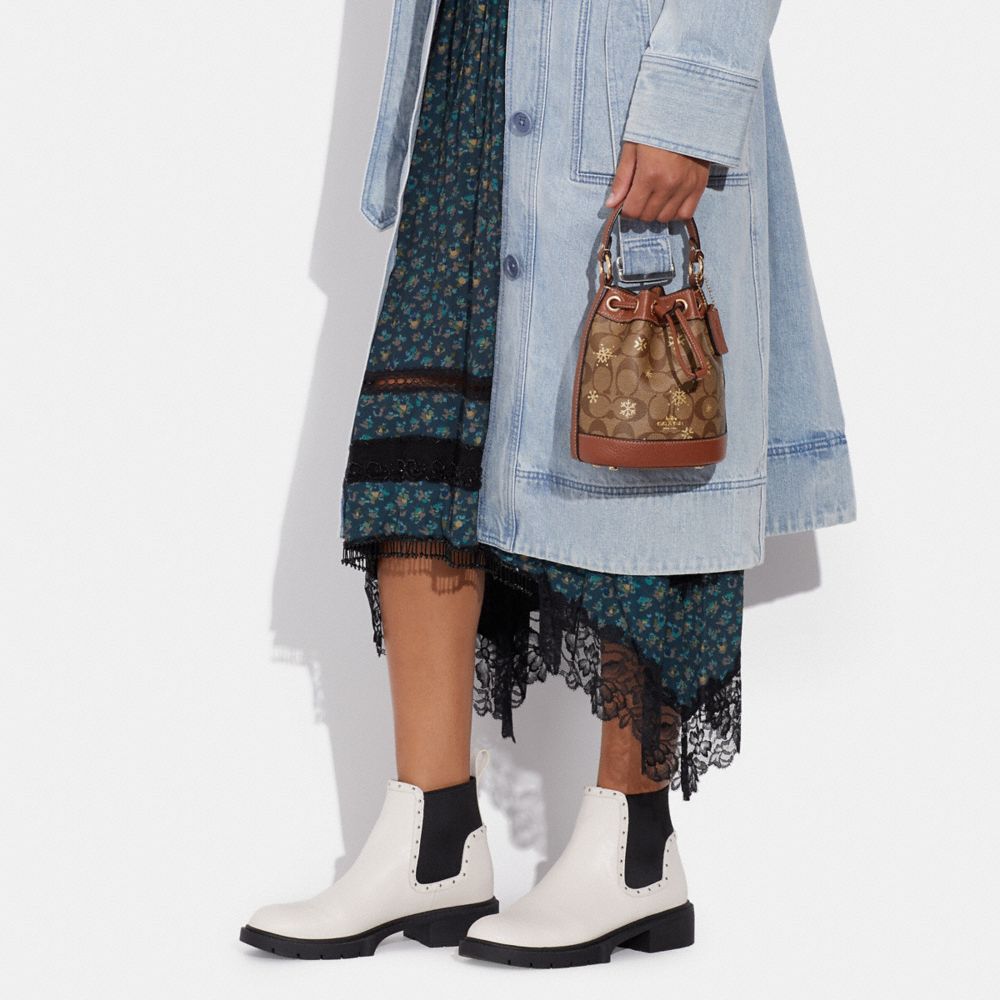 COACH®,Dempsey Drawstring Bucket Bag 15 In Signature Canvas With Snowflake Print,,Detail View