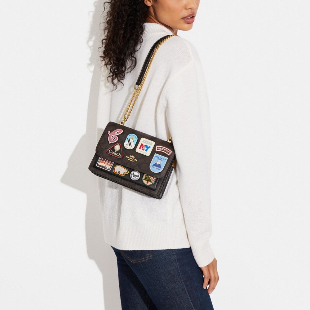COACH®,Klare Crossbody Bag In Signature Canvas With Ski Patches,,Detail View
