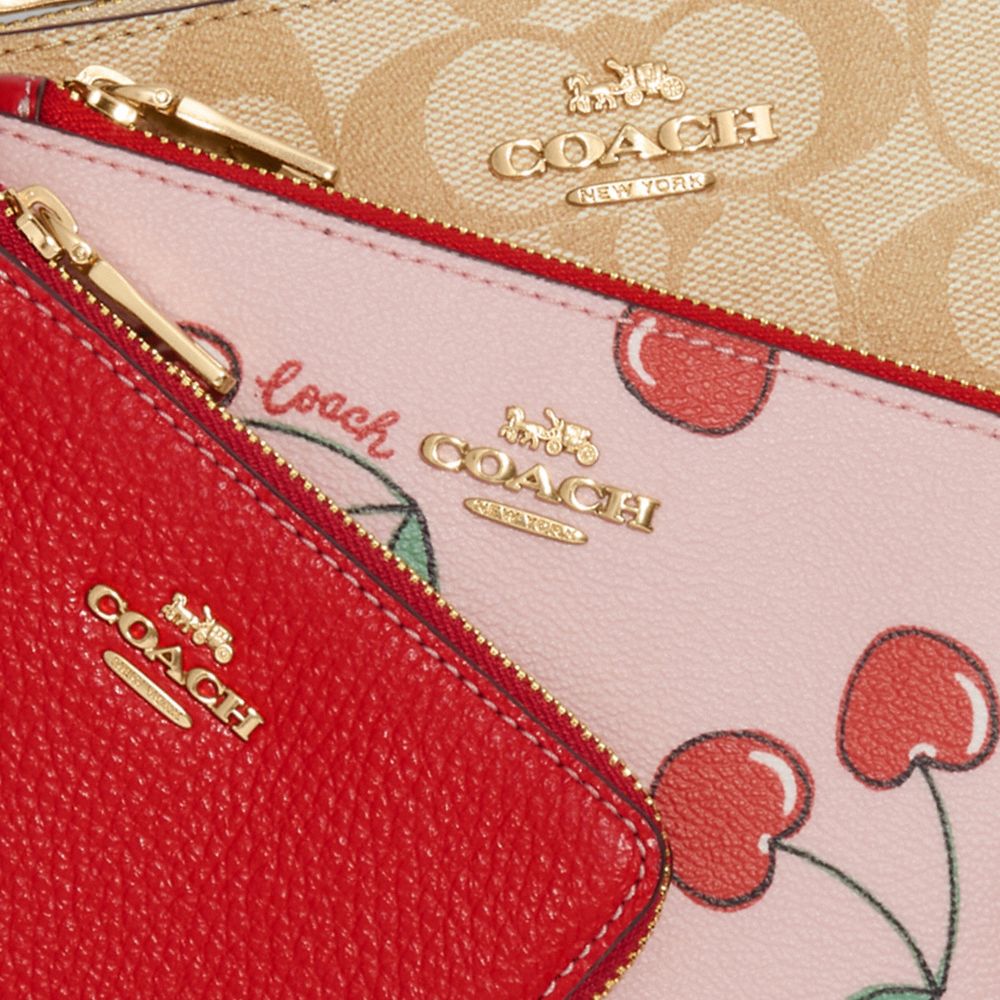 COACH®  Corner Zip Wristlet In Signature Canvas With Heart Cherry