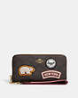 COACH®,LONG ZIP AROUND WALLET IN SIGNATURE CANVAS WITH SKI PATCHES,Mini,Gold/Brown Black Multi,Front View