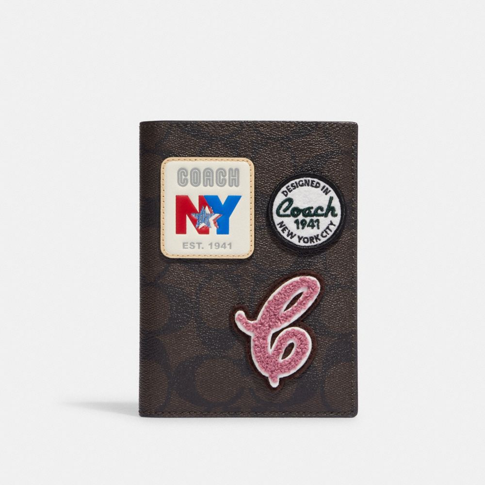 COACH®,PASSPORT CASE IN SIGNATURE CANVAS WITH SKI PATCHES,Gold/Brown Black Multi,Front View