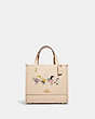 COACH®,COACH X PEANUTS DEMPSEY TOTE 22 WITH SNOOPY AND FRIENDS MOTIF,Refined Pebble Leather,Medium,Gold/Ivory Multi,Front View