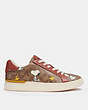 COACH®,COACH X PEANUTS CLIP LOW TOP SNEAKER IN SIGNATURE CANVAS WITH SNOOPY WOODSTOCK PRINT,Signature Coated Canvas,Khaki/ Terracotta,Angle View
