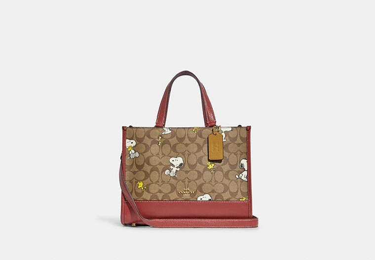 COACH®,COACH X PEANUTS DEMPSEY CARRYALL IN SIGNATURE CANVAS WITH SNOOPY WOODSTOCK PRINT,Signature Coated Canvas,...,Gold/Khaki/Redwood Multi,Front View
