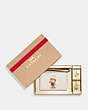 COACH®,BOXED CORNER ZIP WRISTLET WITH BEAR SNOWFLAKE MOTIF,Refined Pebble Leather,Mini,Gold/Chalk Multi,Front View
