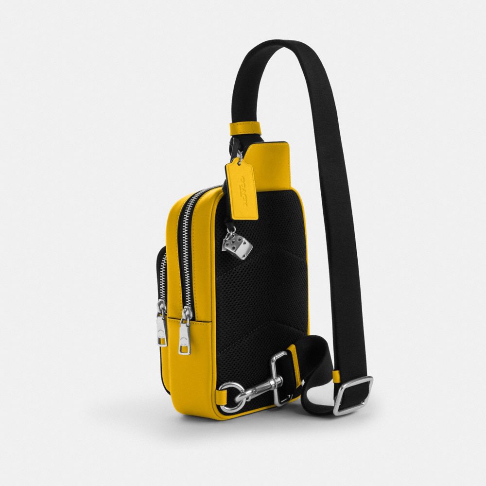 COACH®,Racer Sling Pack In Signature Canvas With Charms,,Angle View