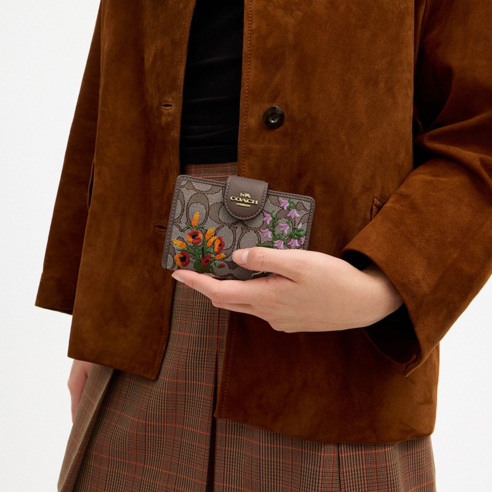 COACH®,Medium Corner Zip Wallet In Signature Jacquard With Floral Embroidery,,Detail View