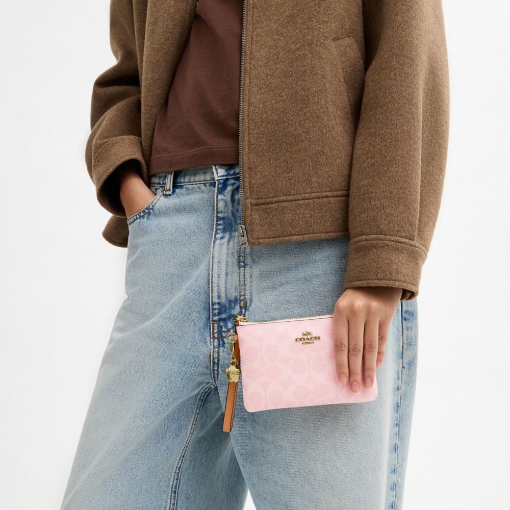 COACH®,Corner Zip Wristlet In Signature Canvas With Charms,Lining Recycled Polyester,Recycled Polyester,Canvas,Leather,Pou...,Pink,Detail View