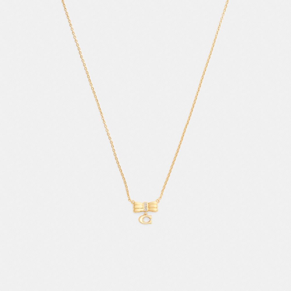 COACH®,Signature Bow Pendant Necklace,Single Strand,Glass,Cubic Zirconia,Initials Embellishment,Lettering Word,Logo,Bow,Ge...,Yellow,Front View