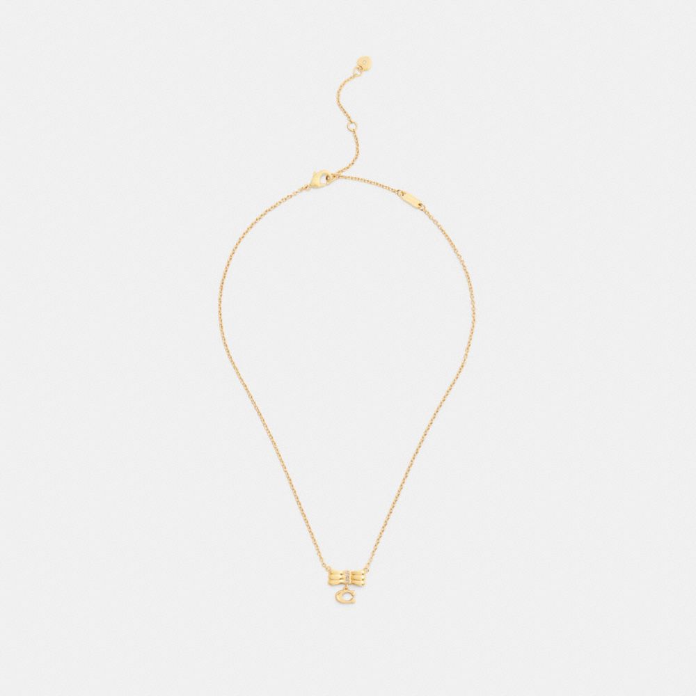 COACH®,Signature Bow Pendant Necklace,Single Strand,Glass,Cubic Zirconia,Initials Embellishment,Lettering Word,Logo,Bow,Ge...,Yellow,Inside View,Top View