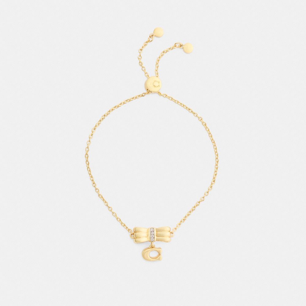 COACH®,Signature Bow Slider Bracelet,Glass,Cubic Zirconia,Disc,Initials Embellishment,Lettering Word,Logo,Bow,Gem Embellis...,Clear,Inside View,Top View