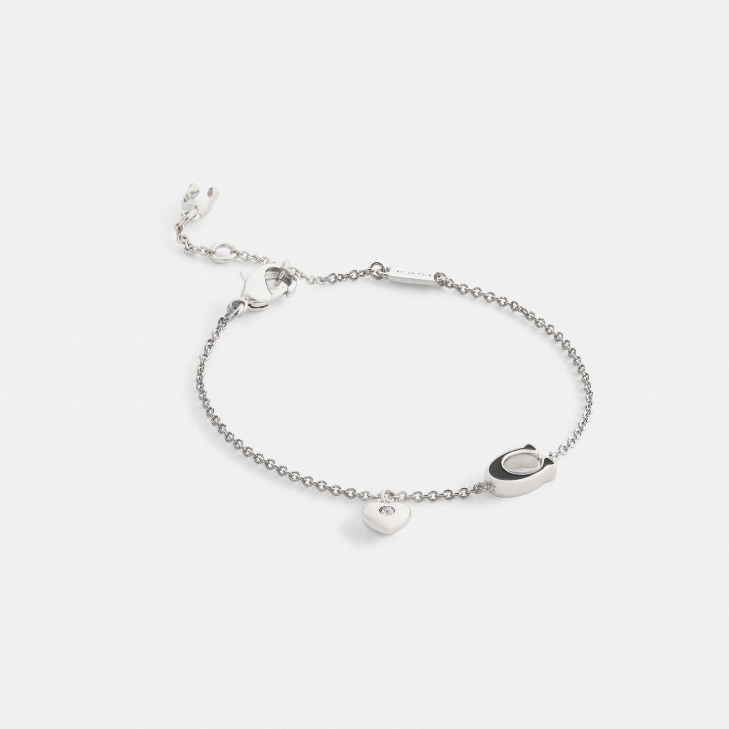 Женский браслет Coach Enamel Signature Heart Charm Linear, цвет: Серебряный / Чёрный — фото 1
