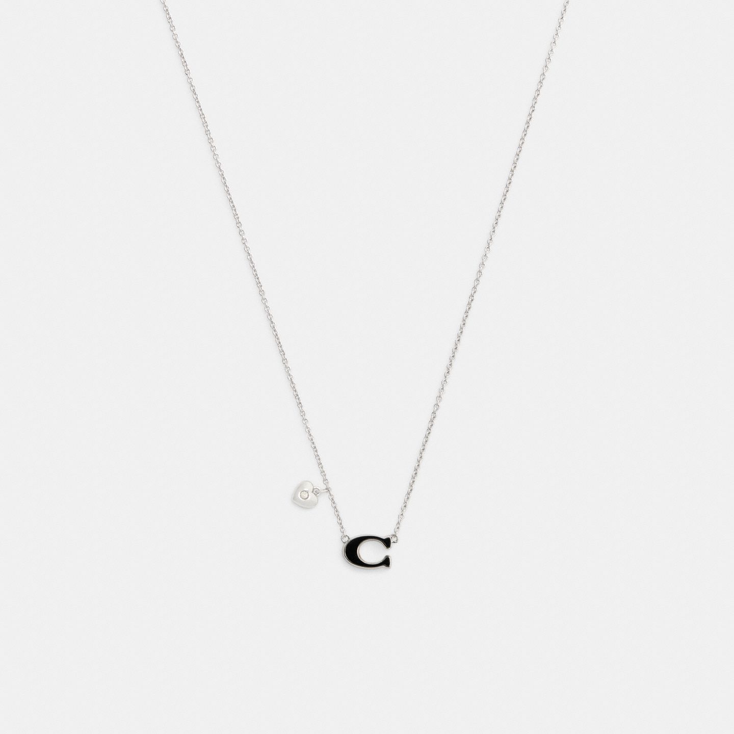 Женское колье Coach Enamel Signature Heart Charm Pendant, цвет: Серебряный / Чёрный — фото 1