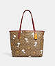 COACH®,COACH X PEANUTS CITY TOTE BAG IN SIGNATURE CANVAS WITH SNOOPY WOODSTOCK PRINT,Signature Coated Canvas,X-L...,Gold/Khaki/Redwood Multi,Front View