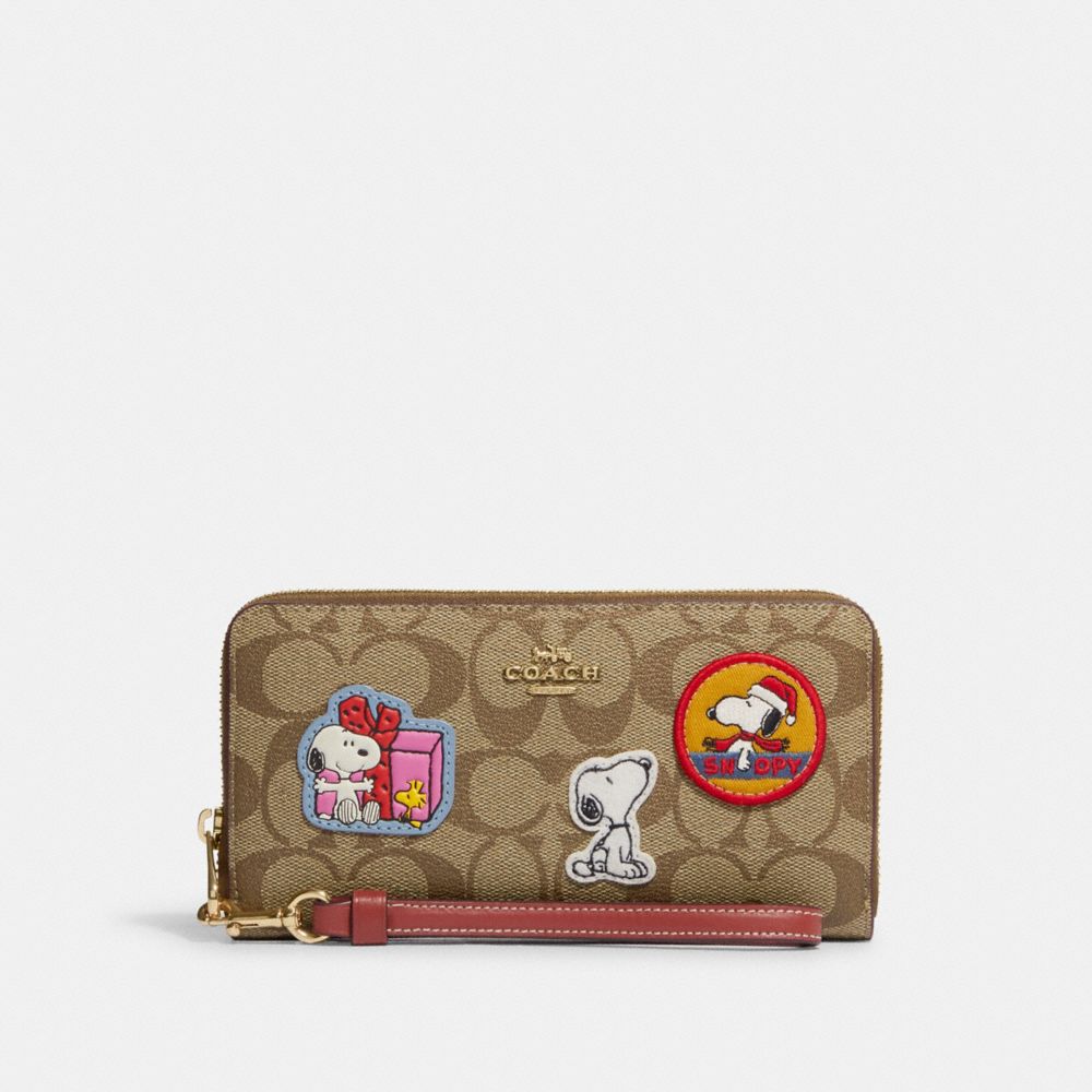 COACH®,COACH X PEANUTS LONG ZIP AROUND WALLET IN SIGNATURE CANVAS WITH PATCHES,Mini,Gold/Khaki/Redwood Multi,Front View