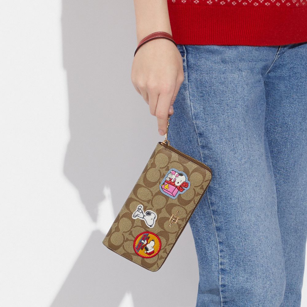 COACH®,COACH X PEANUTS LONG ZIP AROUND WALLET IN SIGNATURE CANVAS WITH PATCHES,Mini,Gold/Khaki/Redwood Multi,Detail View
