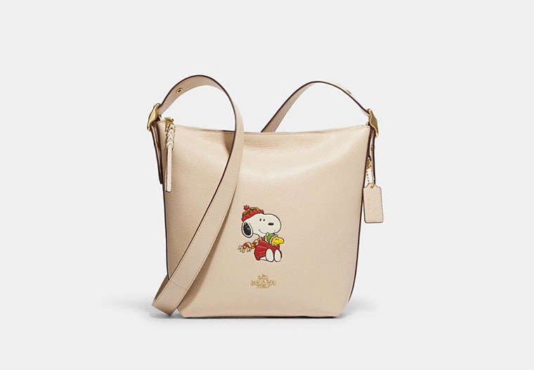 COACH®,COACH X PEANUTS VAL DUFFLE WITH SNOOPY CUDDLE MOTIF,Refined Pebble Leather,Large,Gold/Ivory Multi,Front View