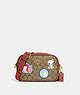 COACH®,COACH X PEANUTS JAMIE CAMERA BAG IN SIGNATURE CANVAS WITH PATCHES,Signature Coated Canvas,Small,Gold/Khaki/Redwood Multi,Front View
