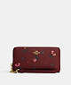 COACH®,LONG ZIP AROUND WALLET WITH HOLIDAY BELLS PRINT,Printed Coated Canvas,Mini,Gold/Black Cherry Multi,Front View