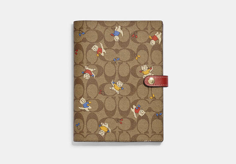 COACH®,NOTEBOOK IN SIGNATURE CANVAS WITH CAT MITTENS PRINT,Signature Coated Canvas,Gold/Khaki Multi,Front View