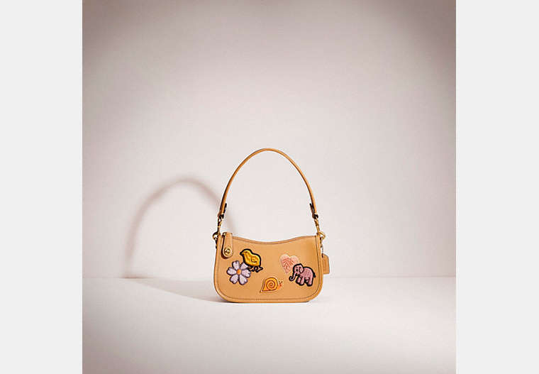 COACH®,RESTORED SWINGER 20 WITH CREATURE PATCHES,Brass/Light Tan Multi,Front View