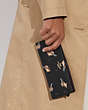 COACH®,SLIM ZIP WALLET WITH PENGUIN PRINT,Printed Coated Canvas,Gold/Black Multi,Detail View
