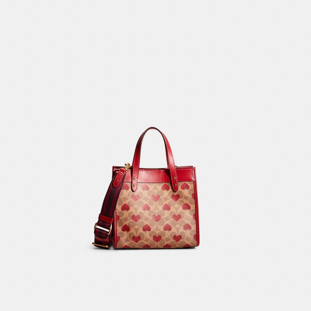 COACH®,RESTORED  FIELD TOTE 22 IN SIGNATURE CANVAS WITH HEART PRINT,Signature Coated Canvas,Medium,Brass/Tan Red Apple,Front View