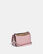 COACH®,LUNAR NEW YEAR BANDIT CROSSBODY IN COLORBLOCK SIGNATURE CANVAS WITH RABBIT CHARM,canvas,Mini,Silver/Tan Powder Pink,Angle View