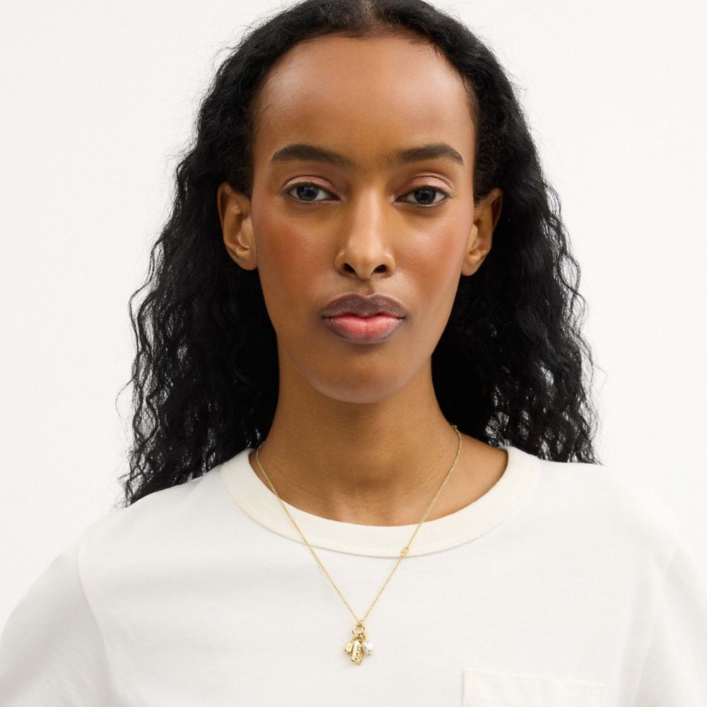 Женские брелоки Coach Pearl Charm Pendant Necklace — фото 3
