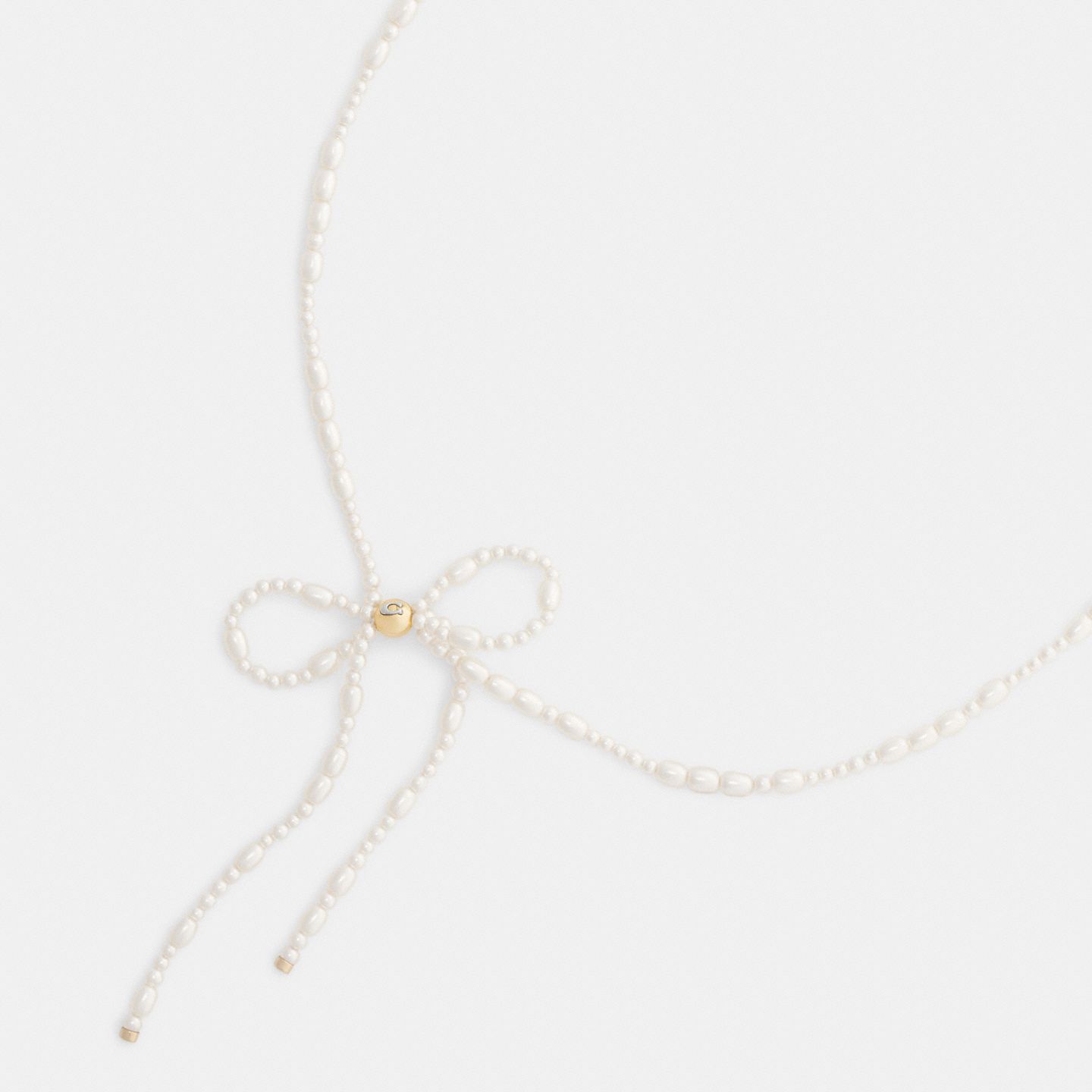 Женские украшения Coach Pearl Bow Choker Necklace, цвет: Золотой / Жемчужный — фото 1