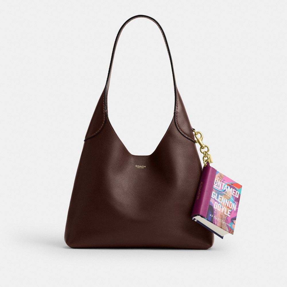 COACH®,Untamed By Glennon Doyle Book Bag Charm,,Angle View