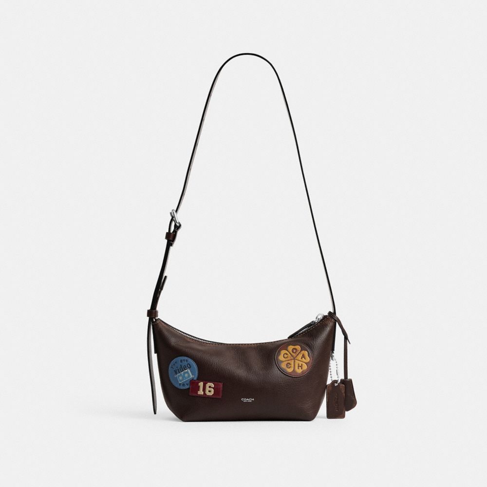 COACH®,Mott Sling Bag 22 In Loved Leather With Stickers,,Front View
